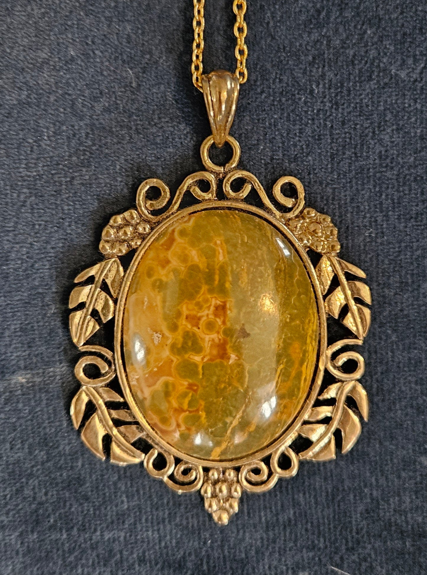 Necklace with Polagonite Jasper collected from Canterbury, South Island New Zealand by a friend of mine and hand polished into a 40x30mm cabochon, set in a gold plated setting with 19 inch chain. This stone shows both the characteristic patterns of this stone of green and yellow dots as well as the stripe pattern. 