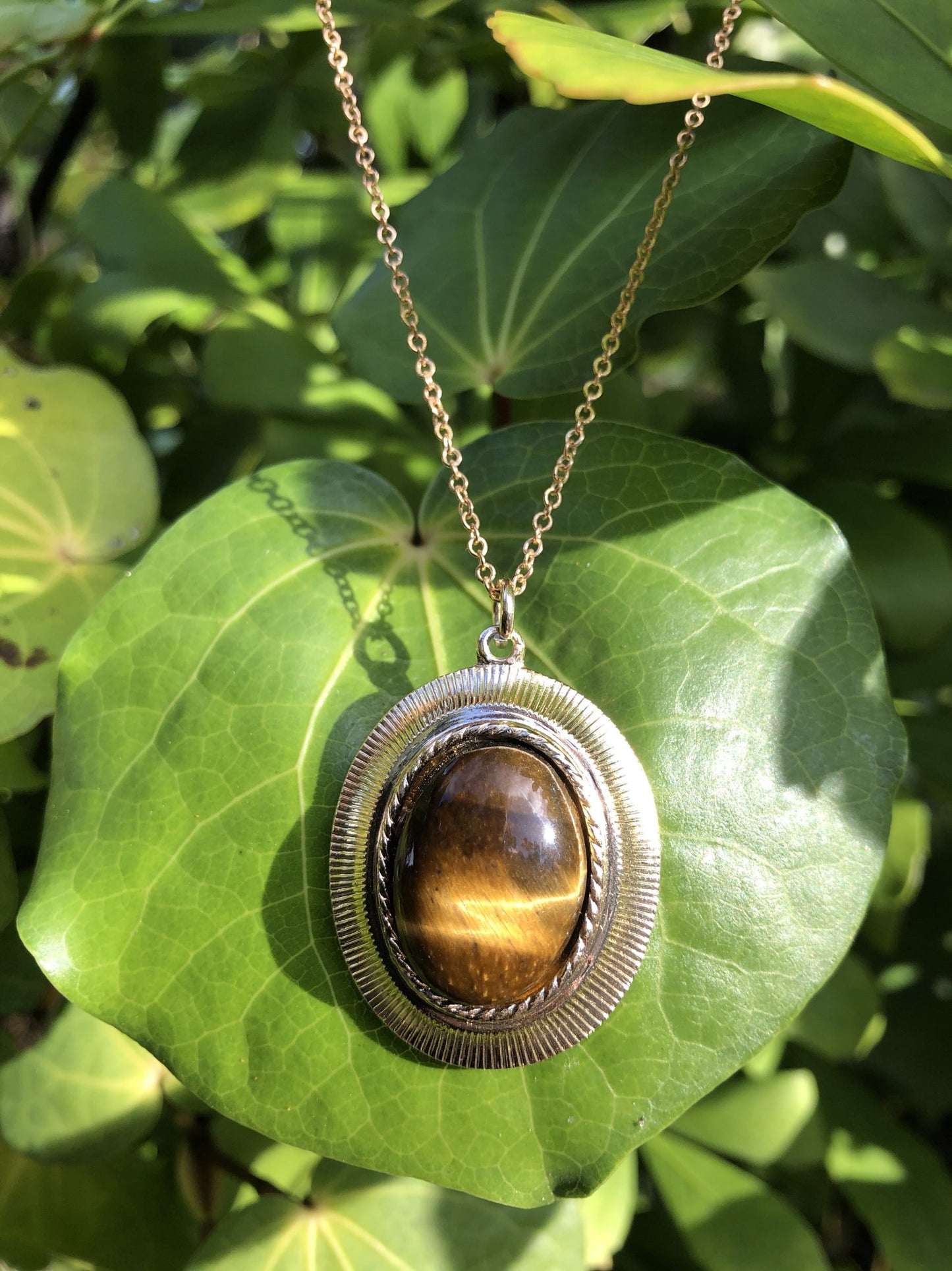 Necklace with golden yellow Tiger's Eye, hand polished to a 20x15mm cabochon and set in a gold-plated setting with 19 inch chain on Kawakawa