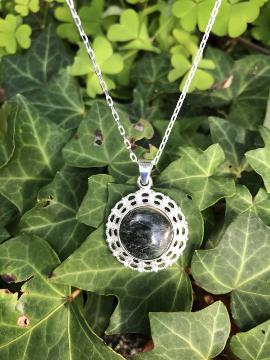 Necklace with New Zealand Pounamu (Greenstone, nephrite jade), dark green with lovely markings, hand polished to a 14mm round cabochon and mounted in a silver plated setting with 19 inch chain.