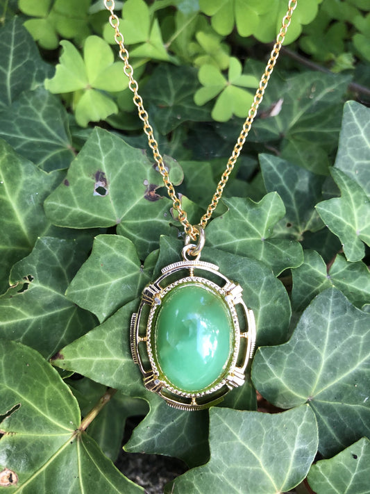 Necklace of brilliant green Australian Chrysoprase, hand polished to a 20x15mm cabochon and set in a gold plated setting with 19 inch chain.