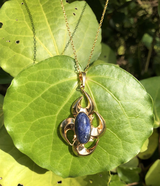 Necklace with natural blue sodalite, hand polished to a 20x10mm cabochon and set in a gold plated setting with 19 inch chain.