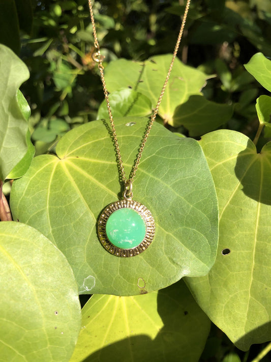 Necklace of brilliant green Australian Chrysoprase, hand polished to a 14mm round cabochon and set in a gold plated setting with 19 inch chain.