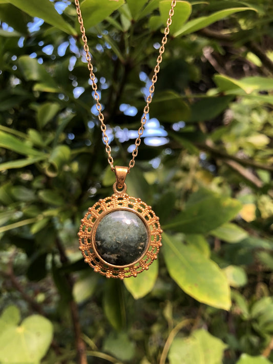 Necklace with natural Australian Nephrite Jade,&nbsp; green with subtle markings, hand polished to a 16mm round cabochon and set in a gold-plated setting with 19 inch chain.
