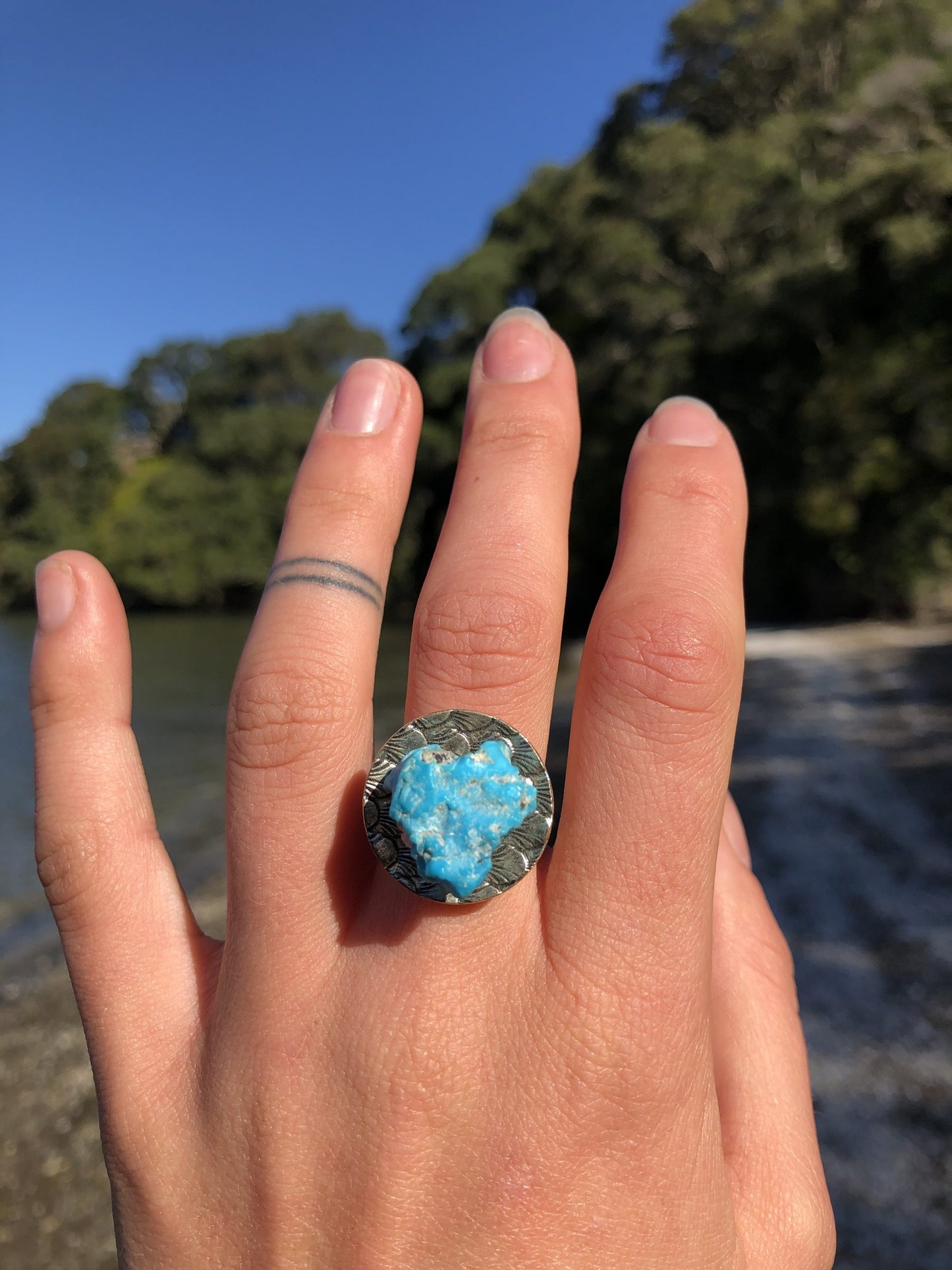 Natural, untreated nugget of Sleeping Beauty turquoisie, brilliant blue with tiny sparkling inclusions of pyrites set in a silver plated adjustable ring