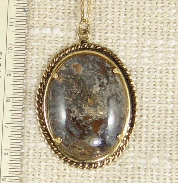 Necklace with an amazing, earthy chert from Coromandel New Zealand with swirls of red, yellow, brown, grey and black creating layers of ethereal visions in earthy tones. This stone is hand polished in a 40x30mm cabochon and set in a gold plated setting with a 19 inch chain.