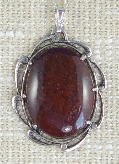 Necklace with a deep purple rhyolite that I collected from the Broken Hills region of the Coromandel Peninsula in New Zealand and hand polished into a 40x30mm cabochon, set in silver plated setting with 19 inch chain.