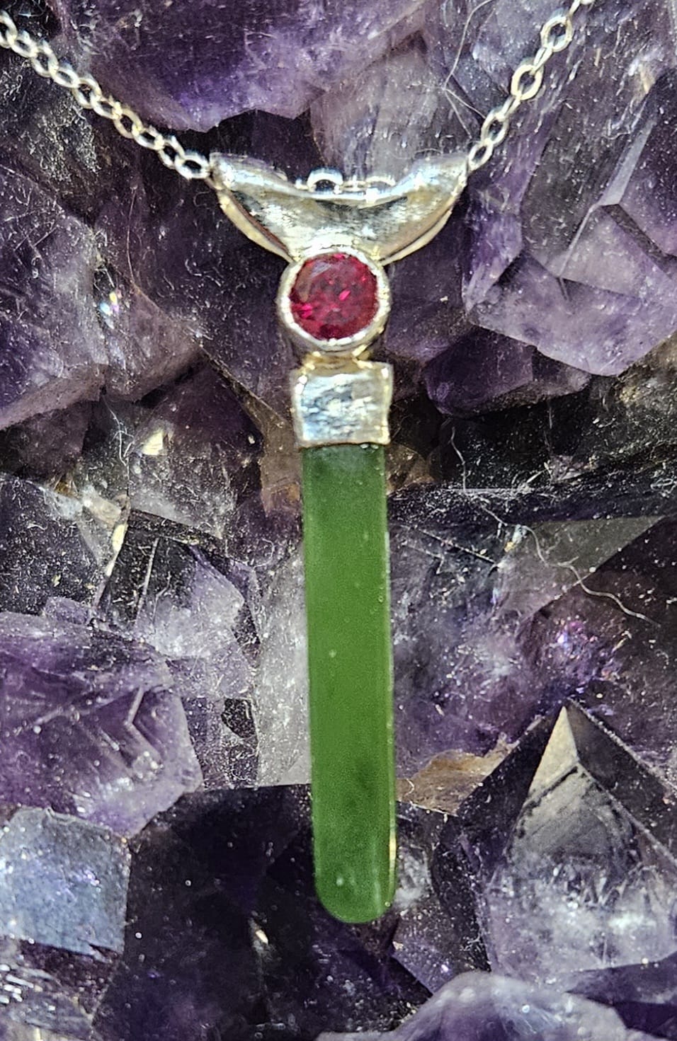Necklace with bright, apple green Kahurangi Pounamu drop, 25mm long with a bright red lab-grown real 5mm ruby, front-alt.