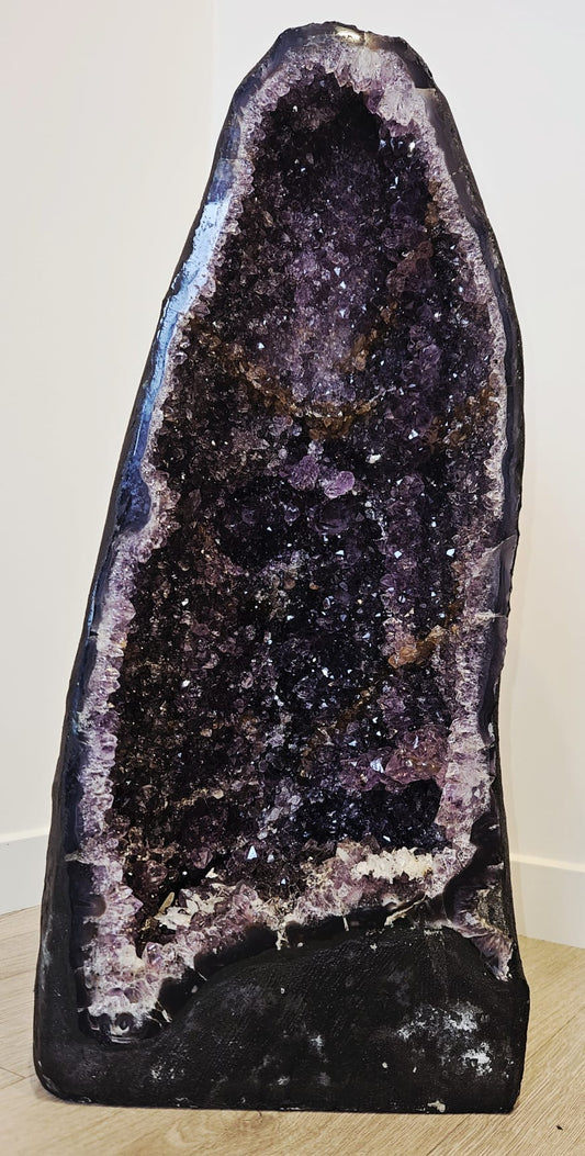 Large amethyst cave with deep purple sparkling crystals, and white calcite crystals at the base. This is 21.5kg, 510mm tall, 245mm wide and 210mm deep, front.