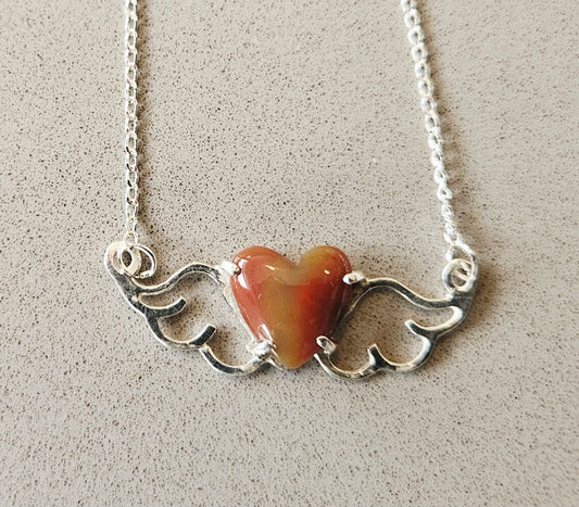 Small (40mm wide) Heart-Wing pendant with a 13x13mm heart cabochon, hand cut and polished from natural New Zealand jasper, all in solid sterling silver and a solid sterling silver chain on gray background.